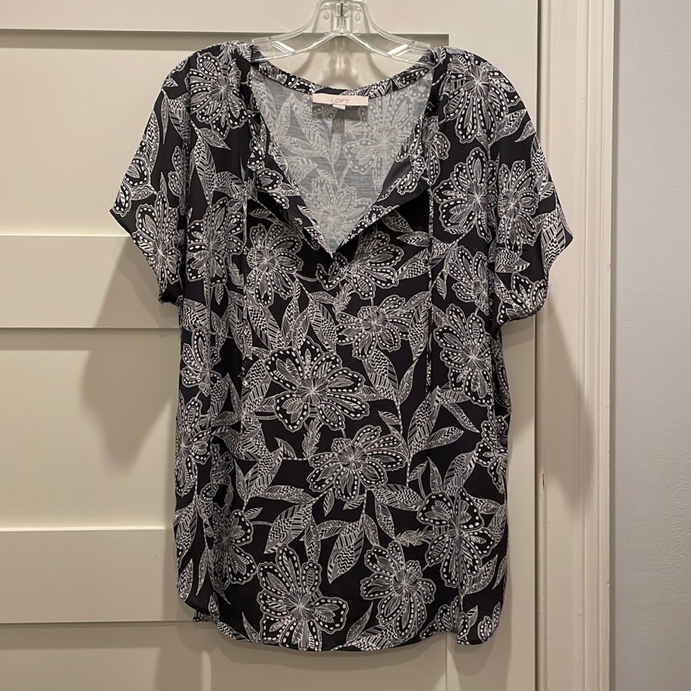 Blue and white flowered top with neck ties and flutter sleeves